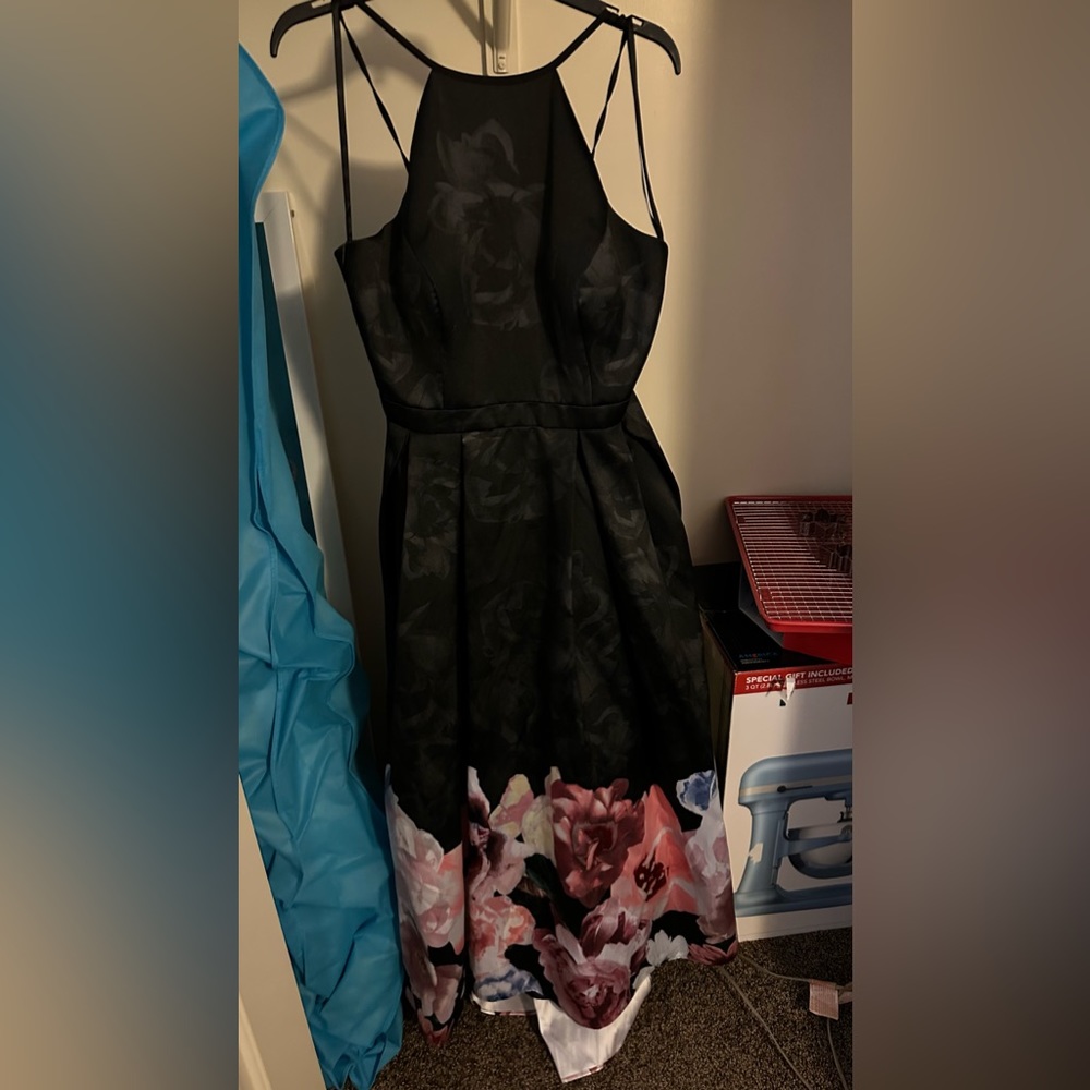 Size 12 black and floral gown. Bra insert cups. Pockets. Small train. Never worn